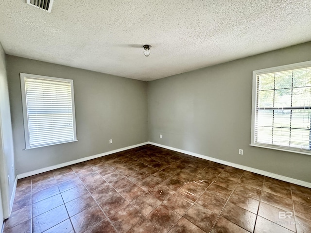 2316 Reneke Ave, Mobile, AL 36605 - spare room featuring a textured ceiling and dark tile patterned floors