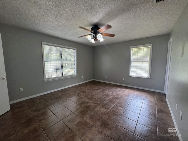 2316 Reneke Ave, Mobile, AL 36605 - spare room featuring ceiling fan, a textured ceiling, and dark tile patterned flooring