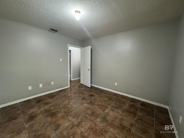2316 Reneke Ave, Mobile, AL 36605 - unfurnished room with a textured ceiling and dark tile patterned flooring