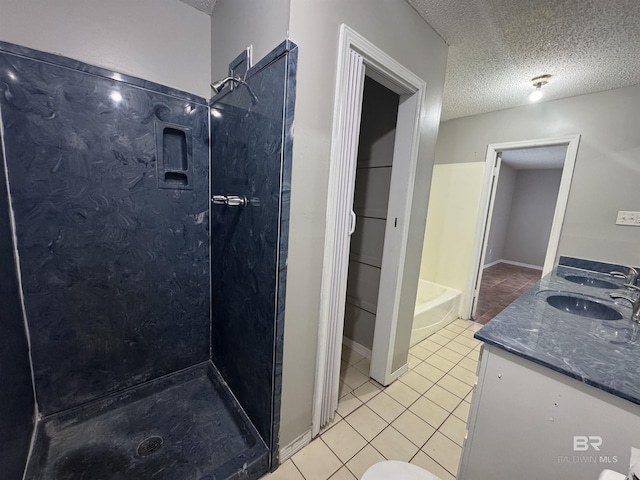 2316 Reneke Ave, Mobile, AL 36605 - full bathroom with tile patterned flooring, walk in shower, double vanity, and a textured ceiling