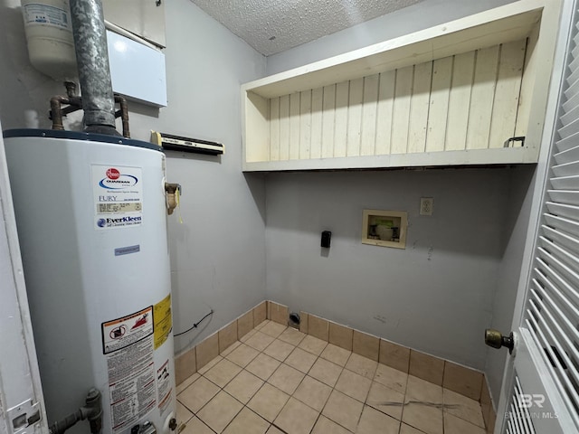 2316 Reneke Ave, Mobile, AL 36605 - washroom with gas water heater, electric dryer hookup, a textured ceiling, tile patterned flooring, and hookup for a washing machine