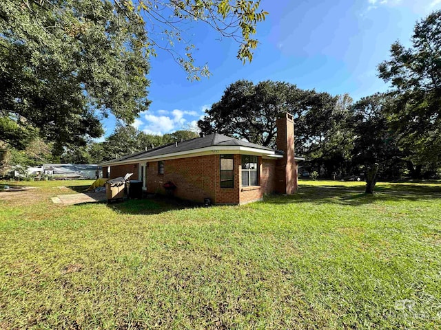 view of home's exterior with a yard