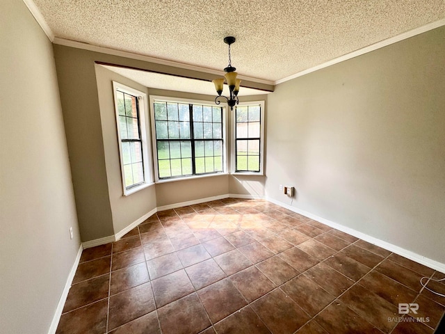 unfurnished dining area featuring ornamental molding, dark tile patterned flooring, a textured ceiling, and an inviting chandelier