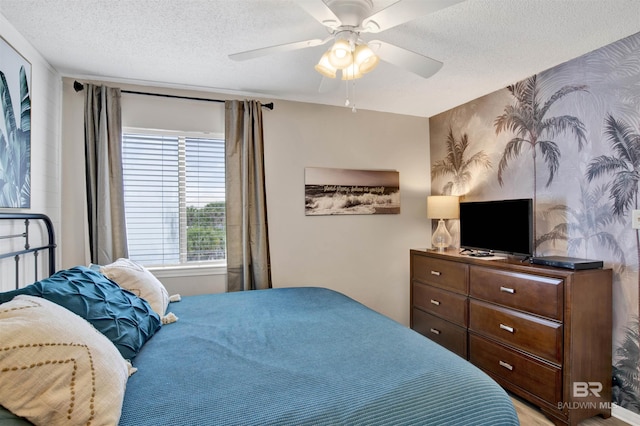 930 W Beach Blvd Unit 106, Gulf Shores, AL 36542 - bedroom with wallpapered walls, a textured ceiling, and ceiling fan