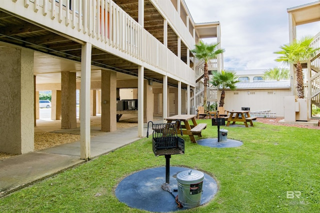 930 W Beach Blvd Unit 106, Gulf Shores, AL 36542 - view of property's community with a yard, stairway, and a patio
