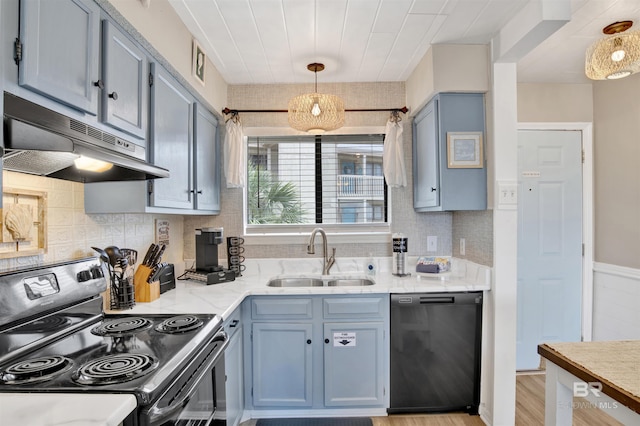 930 W Beach Blvd Unit 106, Gulf Shores, AL 36542 - kitchen featuring electric range, black dishwasher, a sink, under cabinet range hood, and blue cabinets