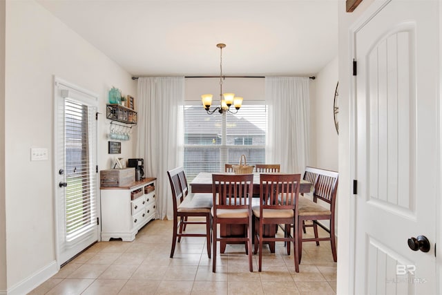 dining area featuring light tile patterned flooring, baseboards, and an inviting chandelier