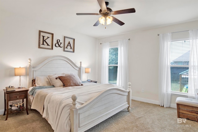 bedroom featuring a ceiling fan, baseboards, and light carpet