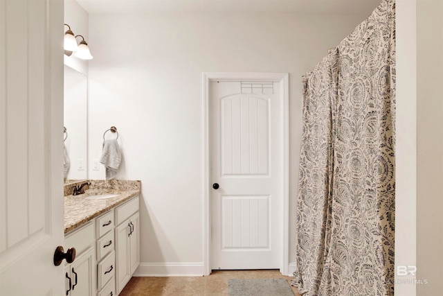 bathroom featuring vanity, tile patterned floors, a shower with curtain, and baseboards