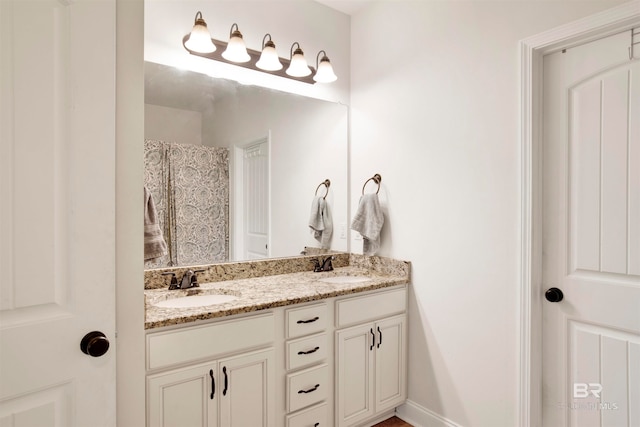 bathroom with double vanity and a sink