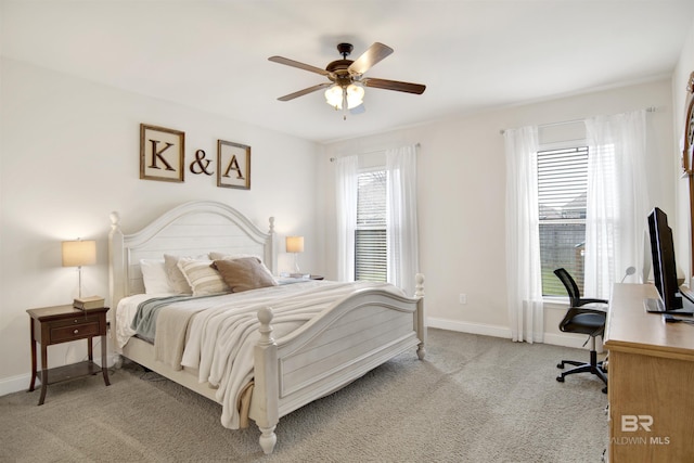 bedroom featuring light colored carpet, baseboards, and ceiling fan