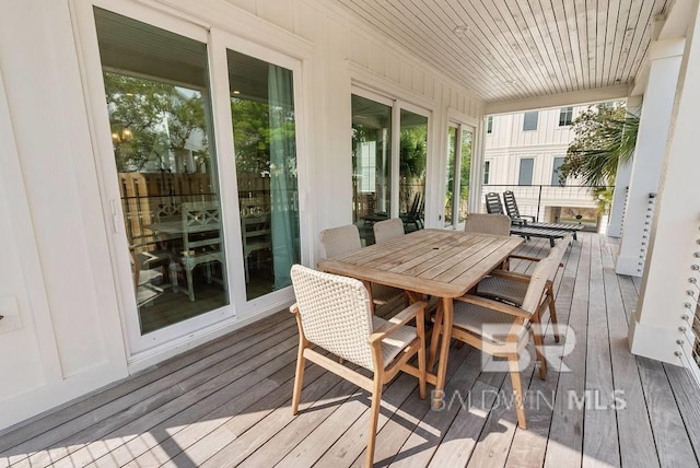 sunroom featuring outdoor dining space and hardwood / wood-style flooring