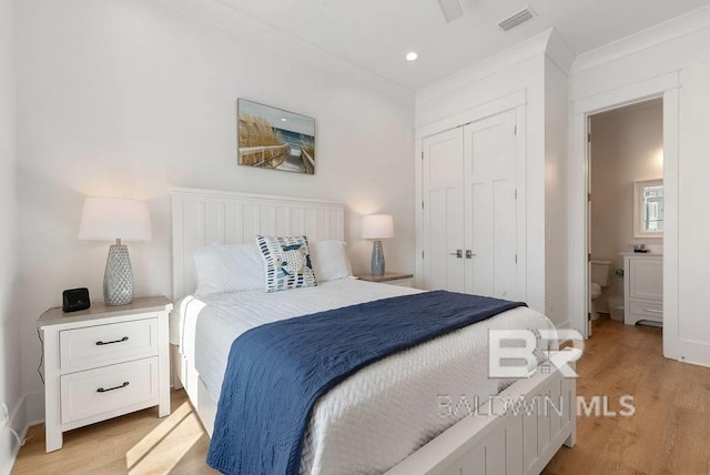 bedroom with a closet, recessed lighting, visible vents, connected bathroom, and light wood-style floors
