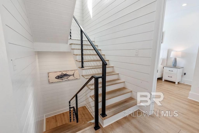 stairs with baseboards and wood finished floors