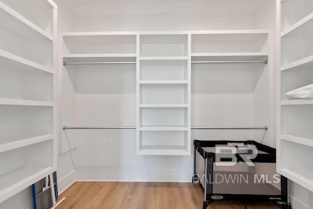 spacious closet with wood finished floors