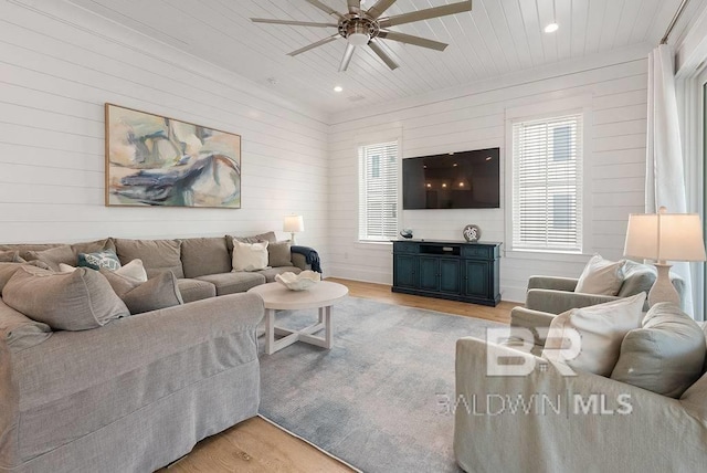 living area featuring light wood-style flooring, ceiling fan, wooden ceiling, wooden walls, and recessed lighting