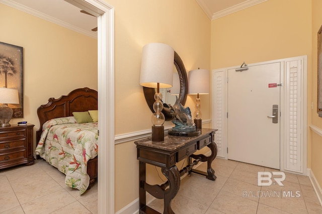 foyer featuring crown molding and light tile patterned floors