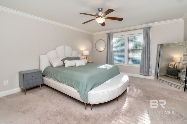 carpeted bedroom featuring ceiling fan and crown molding