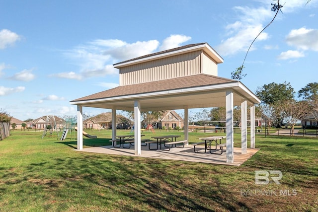 view of home's community with a playground and a yard