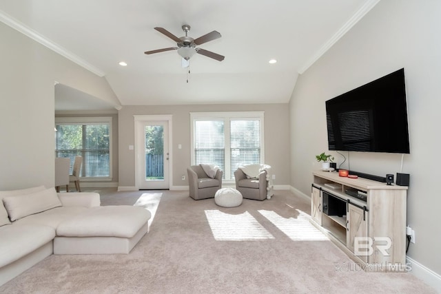 carpeted living room with ceiling fan, lofted ceiling, and ornamental molding