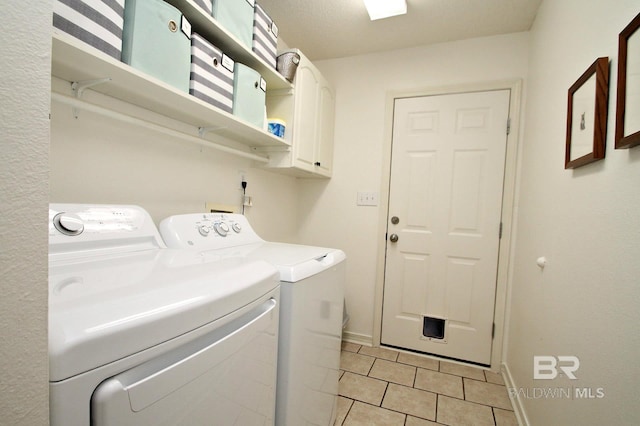 7920 Eagle Creek Dr, Daphne, AL 36526 - laundry area with washer and dryer, light tile patterned floors, cabinet space, and baseboards