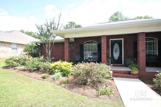 7920 Eagle Creek Dr, Daphne, AL 36526 - view of front of house with a porch, brick siding, and a front lawn