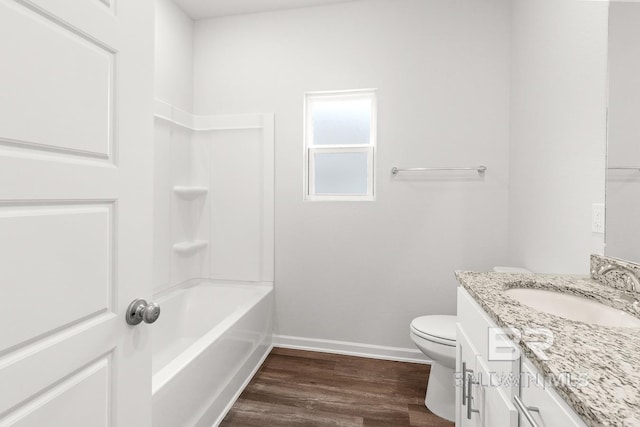 full bathroom with bathtub / shower combination, toilet, vanity, wood finished floors, and baseboards