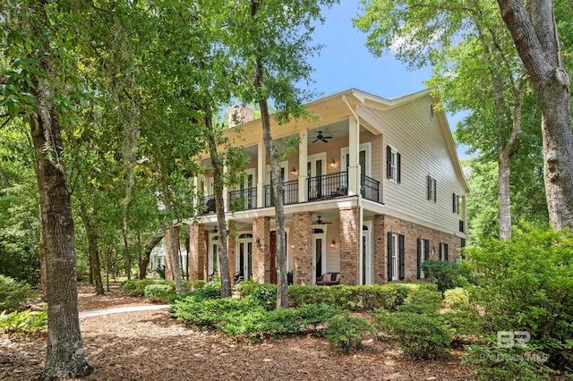 view of front of home with a balcony and ceiling fan