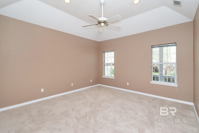 unfurnished room with light colored carpet, plenty of natural light, visible vents, and baseboards