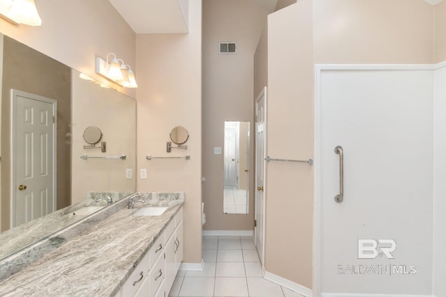 bathroom featuring toilet, vanity, visible vents, tile patterned flooring, and a high ceiling
