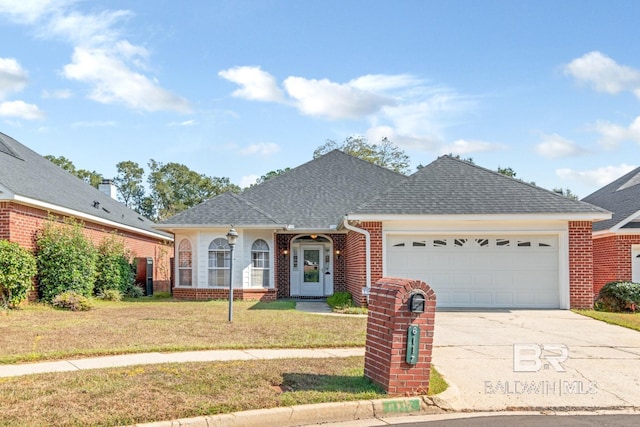 single story home featuring brick siding, a garage, a shingled roof, concrete driveway, and a front yard