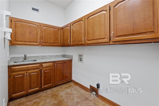 laundry room with washer hookup, cabinets, and sink