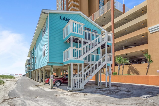 729 W Beach Blvd Unit 129, Gulf Shores, AL 36542 - view of property with stairs and a carport