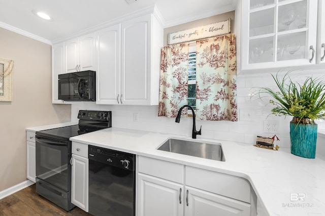 kitchen featuring white cabinetry, sink, dark hardwood / wood-style floors, backsplash, and black appliances