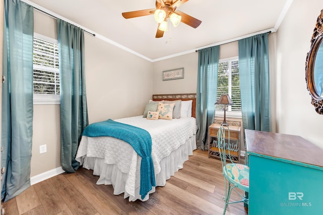 bedroom with ceiling fan, ornamental molding, and light wood-type flooring