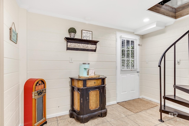 interior space featuring ornamental molding and light tile patterned floors