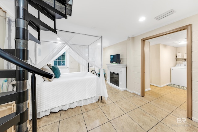 tiled bedroom featuring washer / clothes dryer