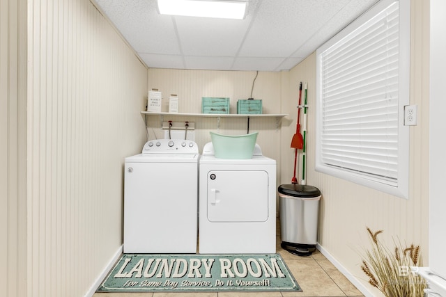 laundry room featuring light tile patterned floors and washing machine and dryer