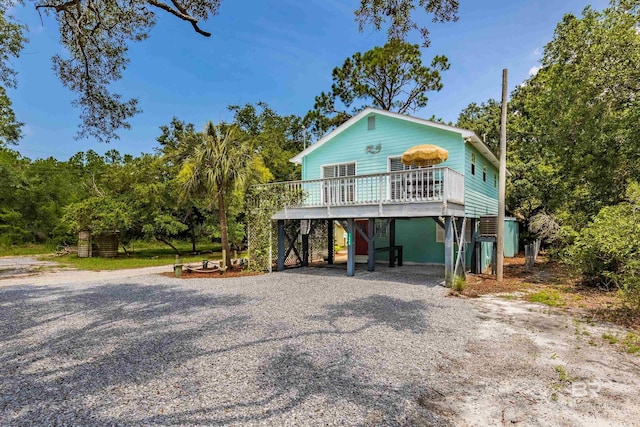 raised beach house with a deck and a carport