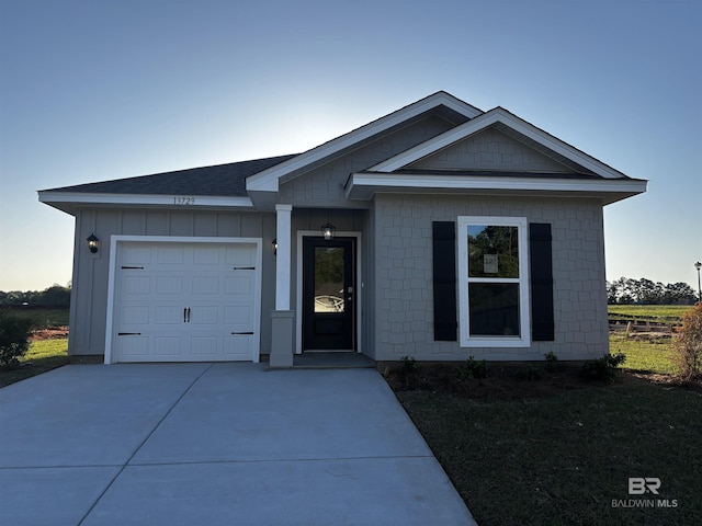 13729 Shea Cir, Foley, AL 36535 - view of front facade featuring driveway, an attached garage, board and batten siding, and roof with shingles
