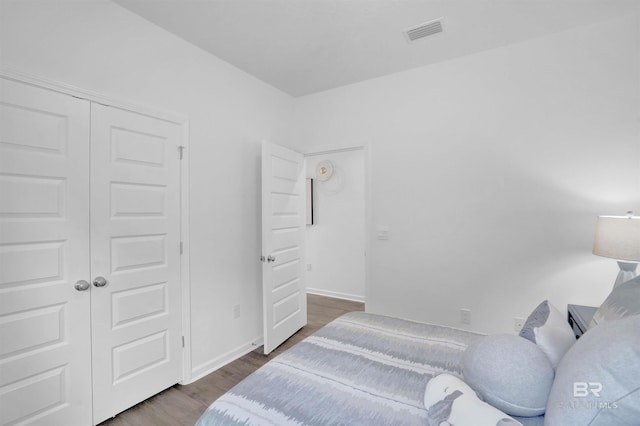13729 Shea Cir, Foley, AL 36535 - bedroom featuring wood finished floors, a closet, and baseboards