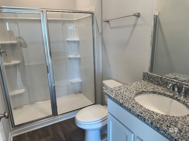 13729 Shea Cir, Foley, AL 36535 - full bathroom featuring a stall shower, wood finished floors, toilet, and vanity