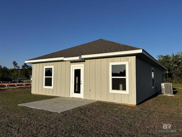 13729 Shea Cir, Foley, AL 36535 - back of property featuring central AC unit, a lawn, roof with shingles, a patio, and board and batten siding