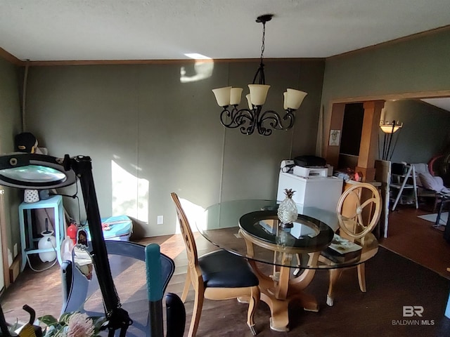 dining area with wood-type flooring and a chandelier