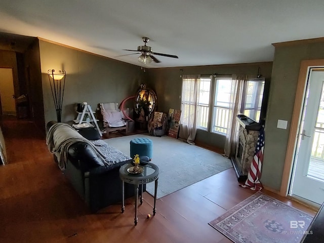 living room featuring ceiling fan and a healthy amount of sunlight