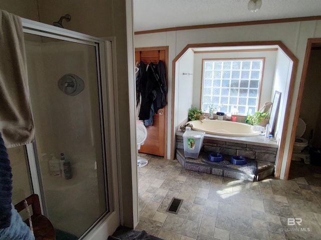 bathroom with plus walk in shower, a textured ceiling, toilet, and crown molding