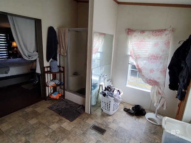 bathroom featuring an enclosed shower and ornamental molding