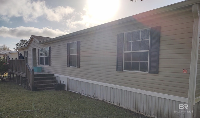 view of side of property with a yard