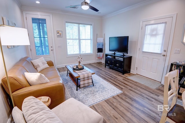 living room with ceiling fan, crown molding, and light hardwood / wood-style floors