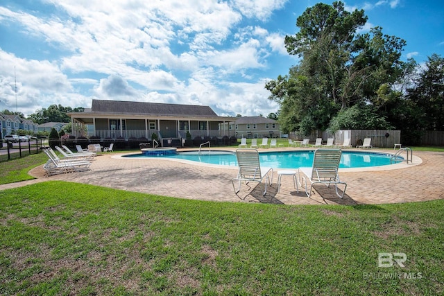 view of swimming pool featuring a lawn and a patio area